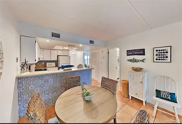 a living room with furniture and a dining table