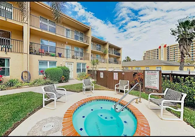 a view of a chairs and table in backyard of the house