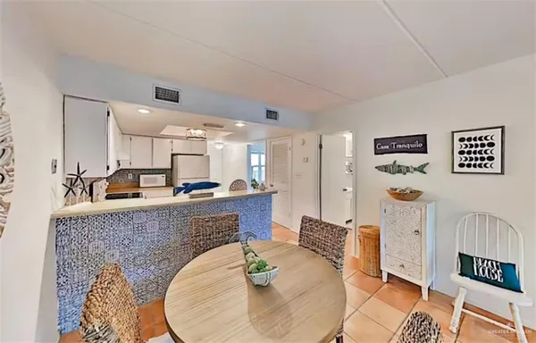 a living room with furniture and kitchen view