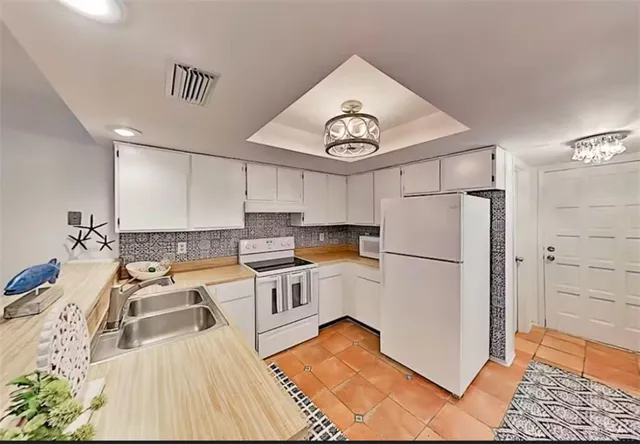 a kitchen with a sink appliances and cabinets