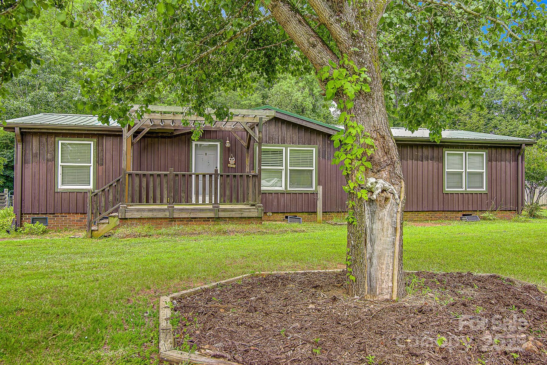 5165 Woodleaf Road Salisbury, NC 28147 - Photo 1 of 48 a front view of a house with garden