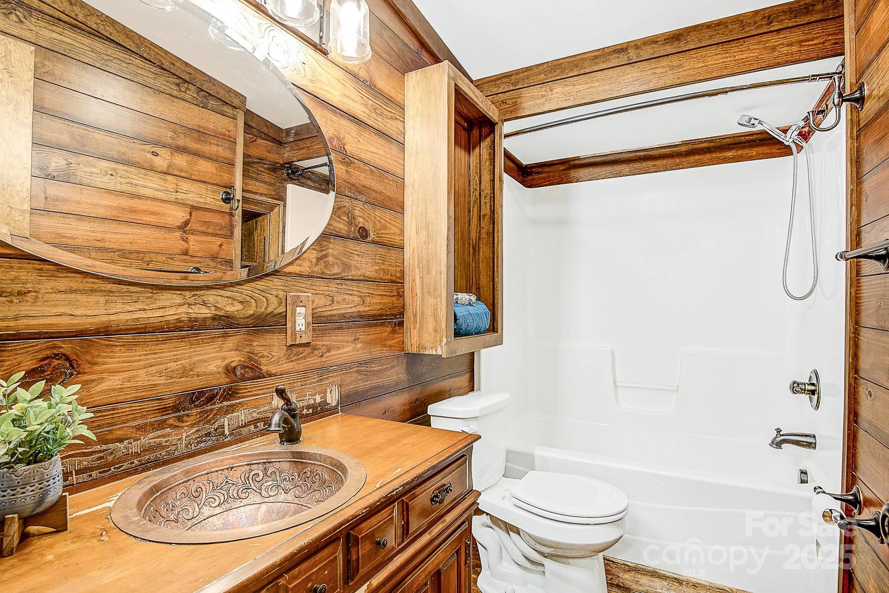 5165 Woodleaf Road Salisbury, NC 28147 - Photo 23 of 48 a bathroom with a sink and a mirror