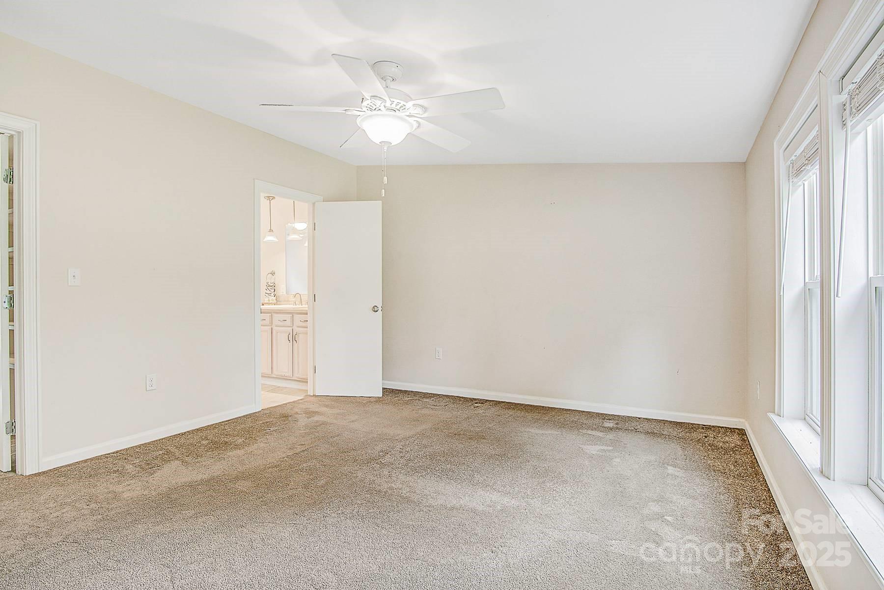 5165 Woodleaf Road Salisbury, NC 28147 - Photo 25 of 48 an empty room with a window and a ceiling fan