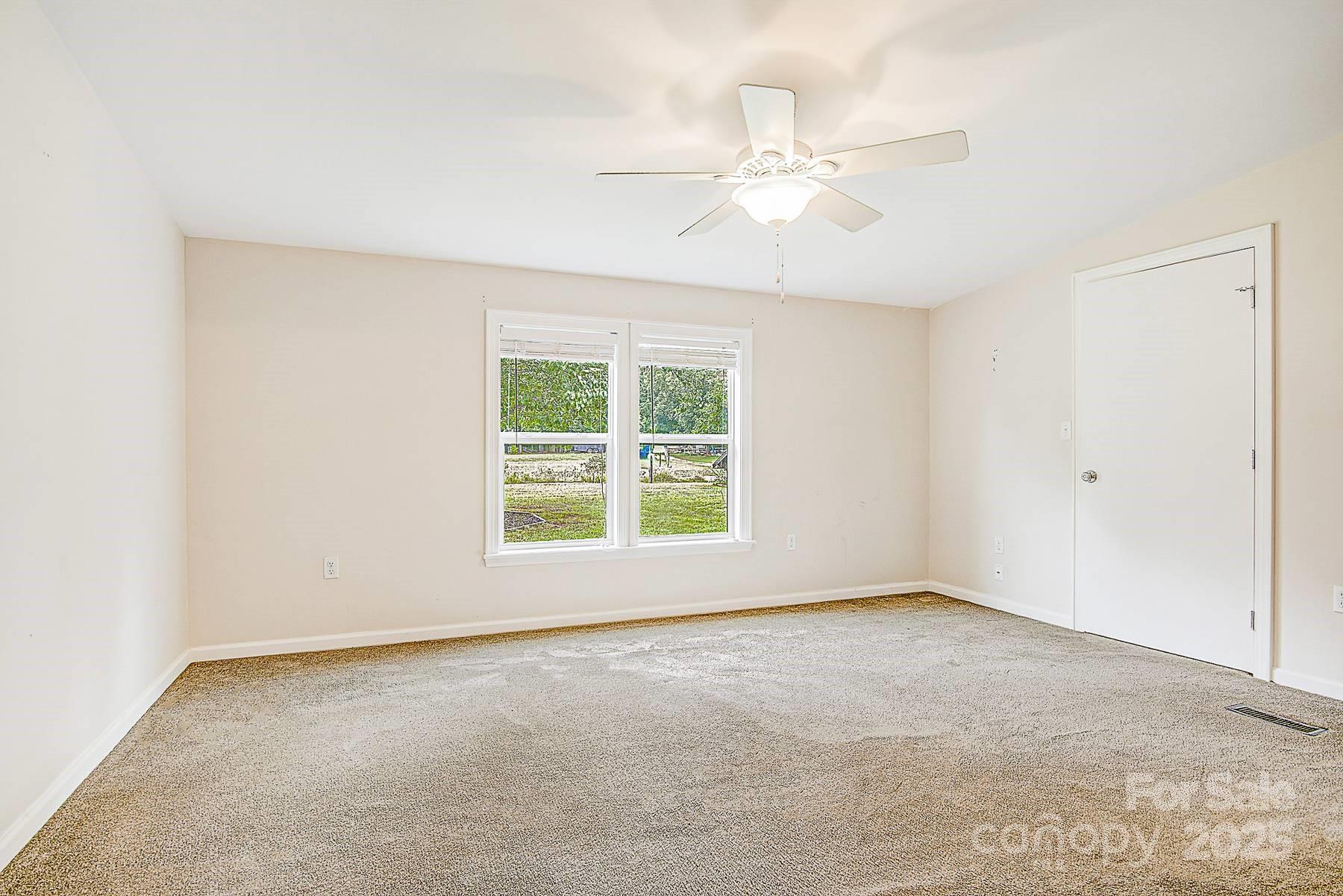 5165 Woodleaf Road Salisbury, NC 28147 - Photo 29 of 48 an empty room with windows and fan