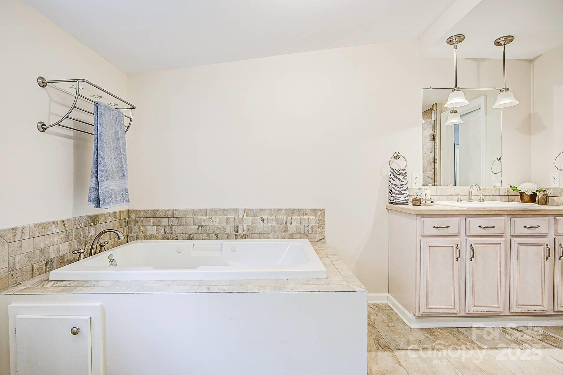 5165 Woodleaf Road Salisbury, NC 28147 - Photo 35 of 48 a bathroom with a sink and a mirror