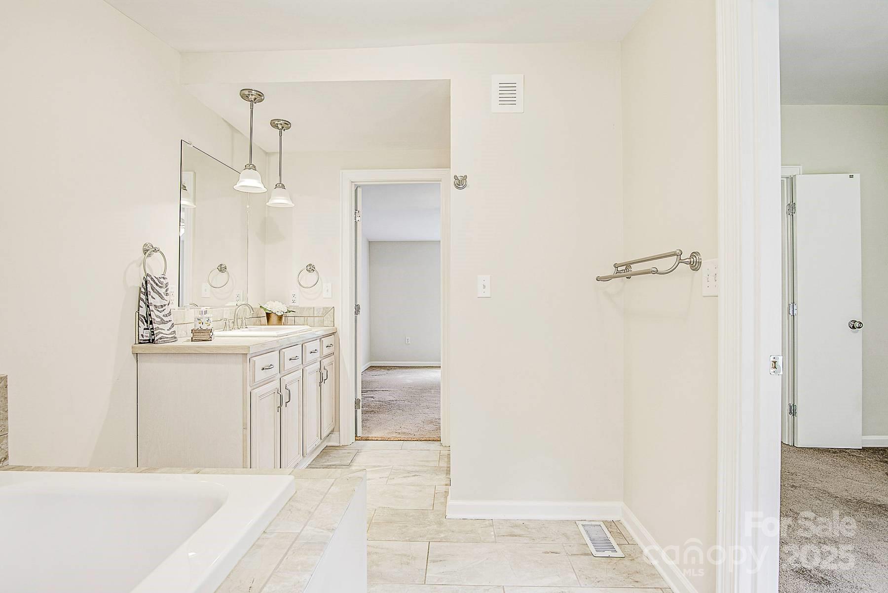 5165 Woodleaf Road Salisbury, NC 28147 - Photo 36 of 48 a large bathroom with a sink a mirror and a shower