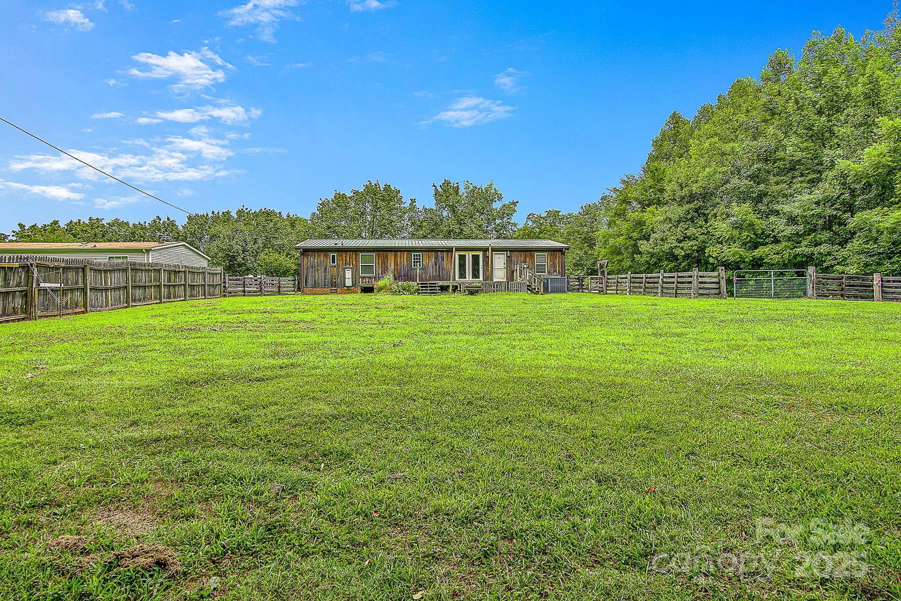 5165 Woodleaf Road Salisbury, NC 28147 - Photo 45 of 48 a view of a green yard with a house