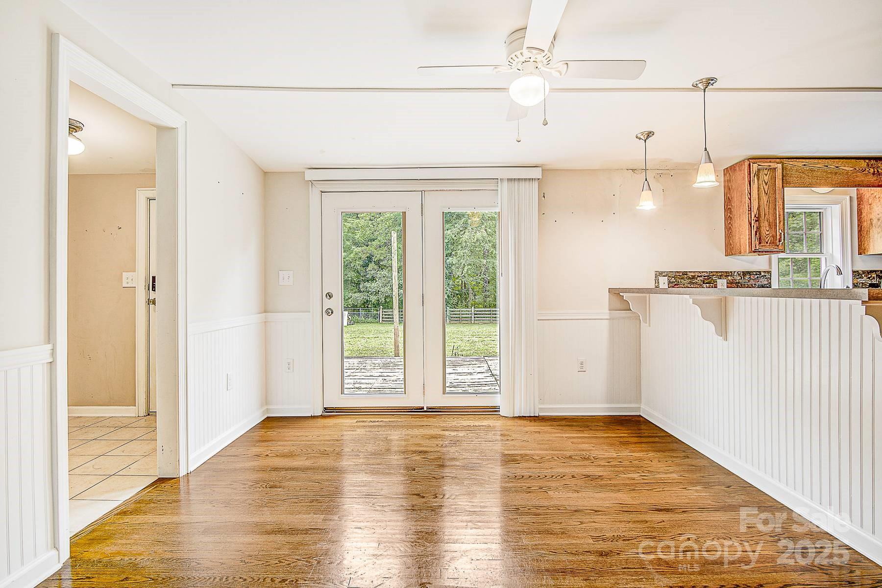 5165 Woodleaf Road Salisbury, NC 28147 - Photo 10 of 48 a view of a kitchen with wooden floor and a window