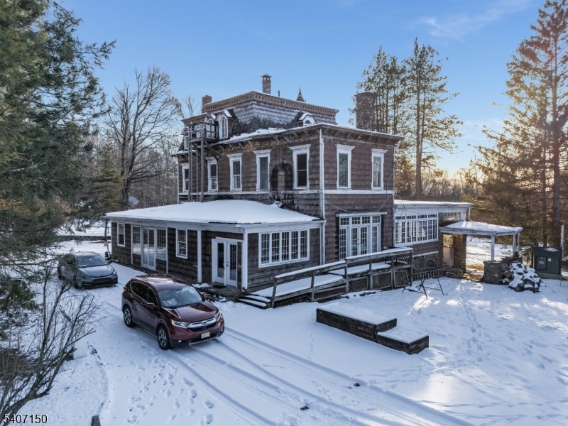 50 Drakestown Road Hackettstown, NJ 07840 - Photo 15 of 47 a roof deck with table and chairs under an umbrella