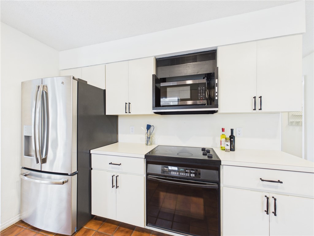 225 Midvale Terrace Sebastian, FL 32958 - Photo 11 of 25 a kitchen with stainless steel appliances a refrigerator stove and microwave