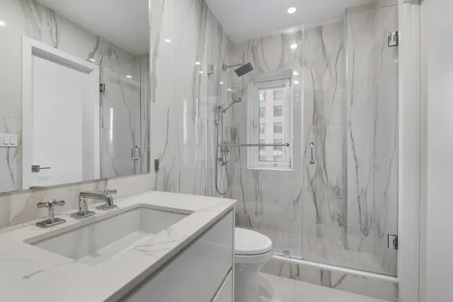 a bedroom with a large bed and a large window