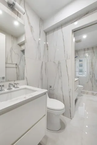 a bathroom with a sink toilet and shower