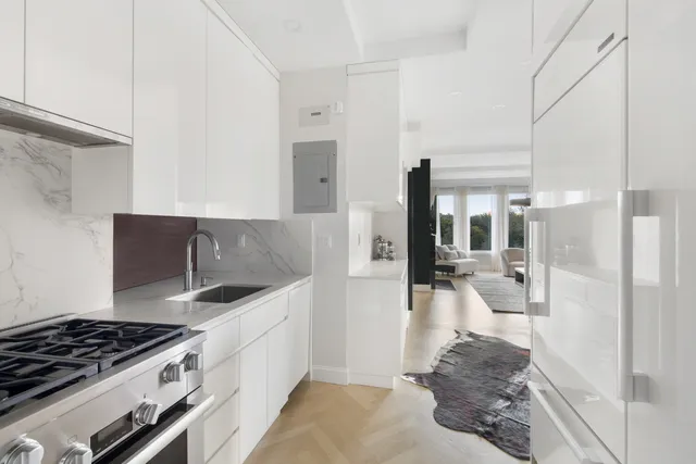 a kitchen with a sink and chairs