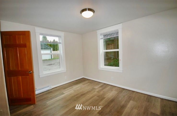 3409 Rockefeller Avenue Everett, WA 98201 - Photo 30 of 31 an empty room with wooden floor and windows