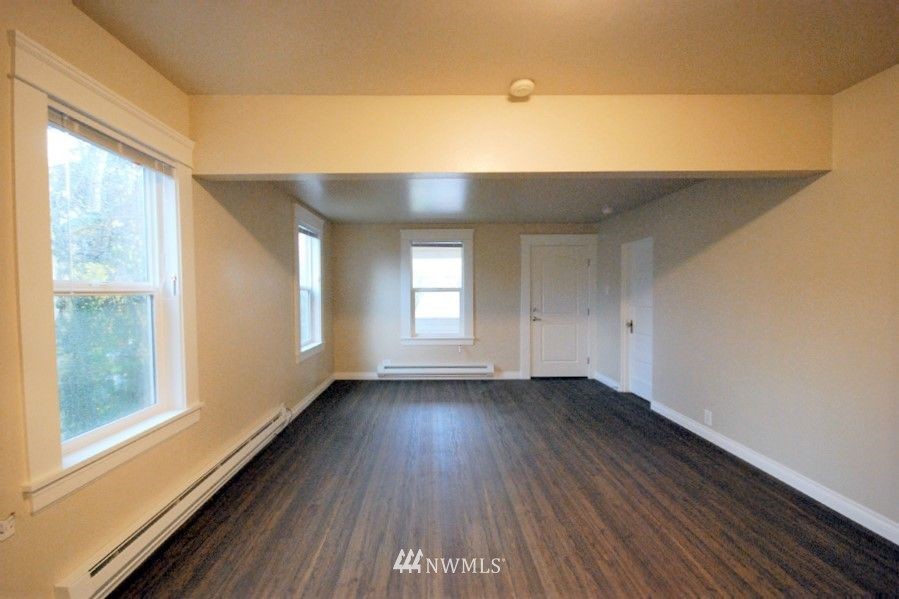 3409 Rockefeller Avenue Everett, WA 98201 - Photo 6 of 31 a view of an empty room with wooden floor and a window