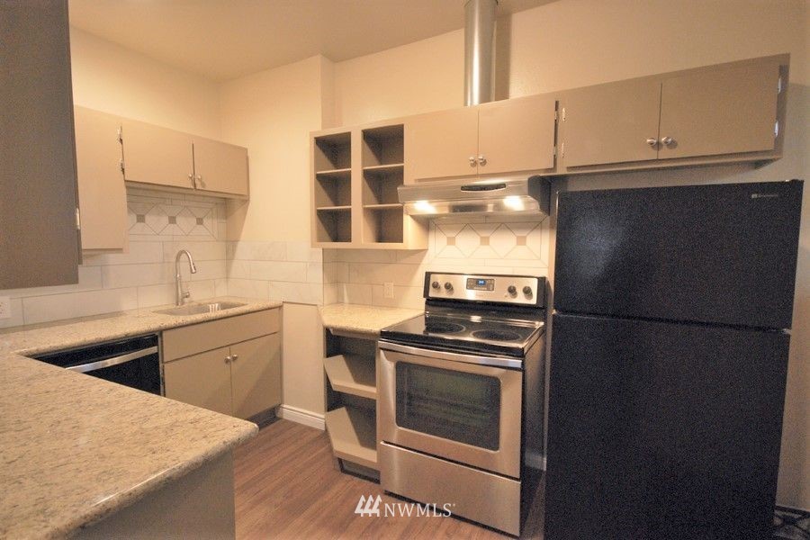 3409 Rockefeller Avenue Everett, WA 98201 - Photo 8 of 31 a kitchen with a refrigerator stove and cabinets