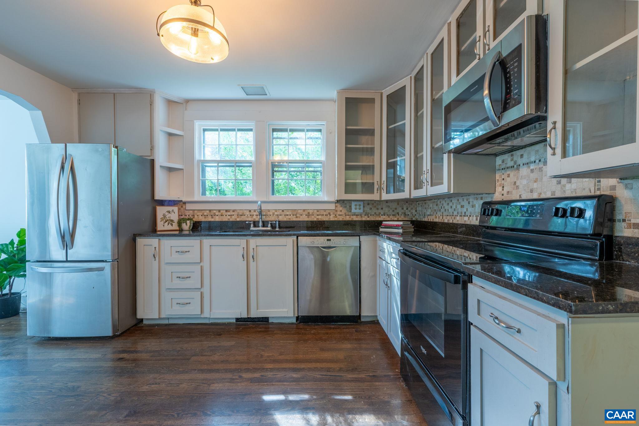 2514 Taylors Gap Road North Garden, VA 22959 - Photo 13 of 75 a kitchen with granite countertop a stove and a refrigerator