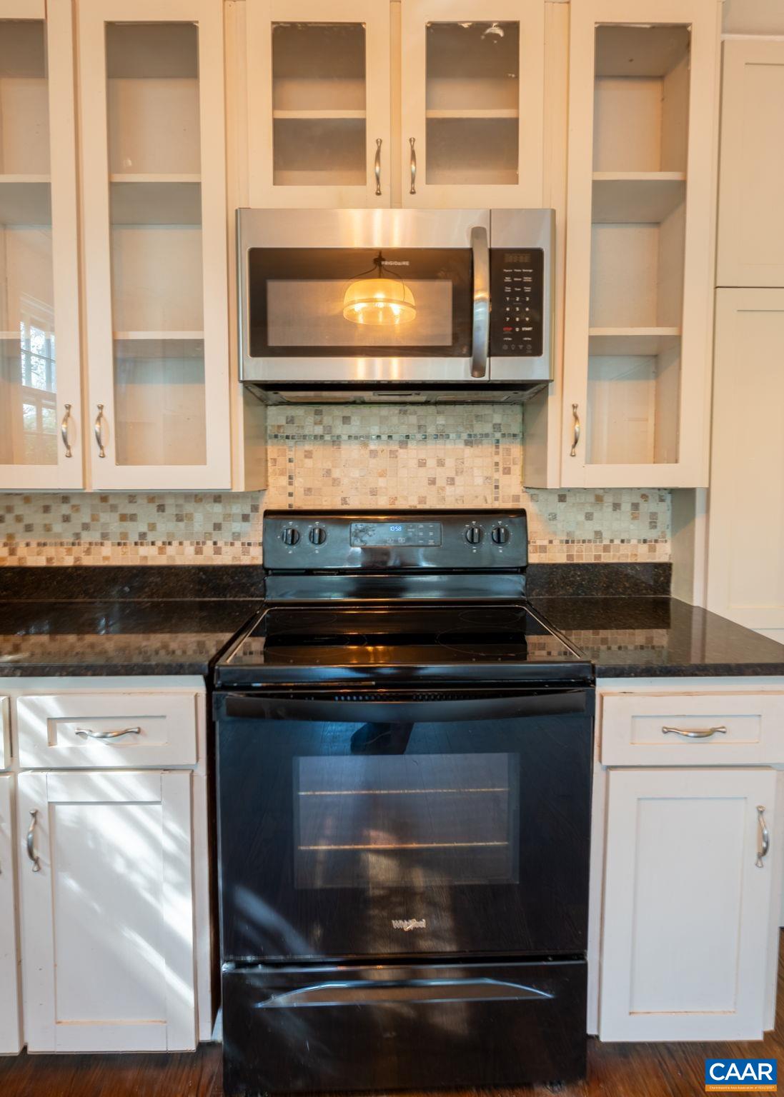 2514 Taylors Gap Road North Garden, VA 22959 - Photo 17 of 75 a stove top oven sitting inside of a kitchen and granite counter tops