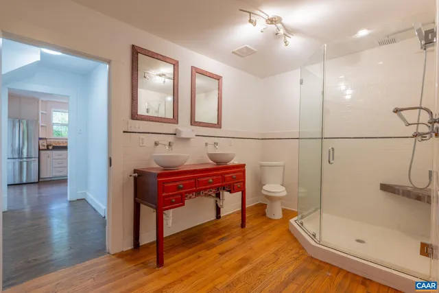 a bathroom with a bath tub with a shower