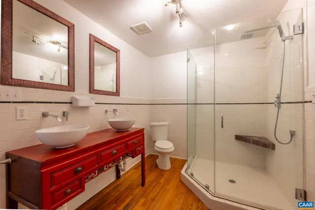 a bathroom with a bath tub with a shower