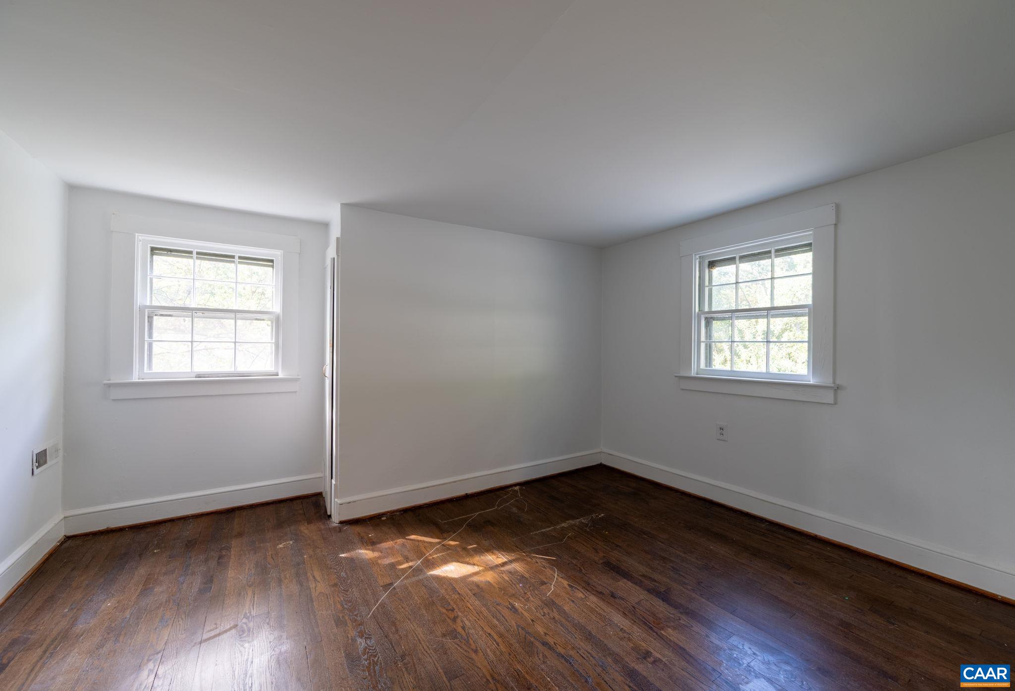 2514 Taylors Gap Road North Garden, VA 22959 - Photo 46 of 75 a view of an empty room with wooden floor and a window