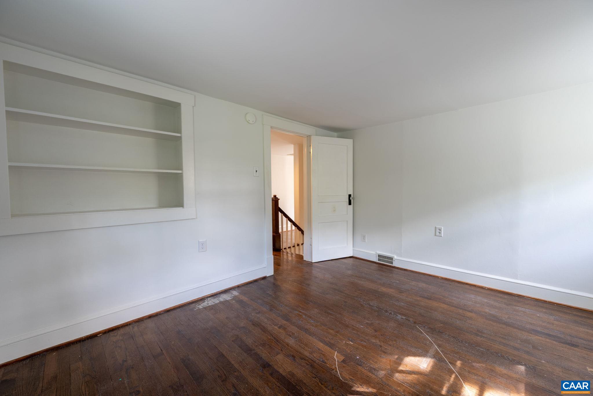 2514 Taylors Gap Road North Garden, VA 22959 - Photo 47 of 75 a view of an empty room with wooden floor and a window