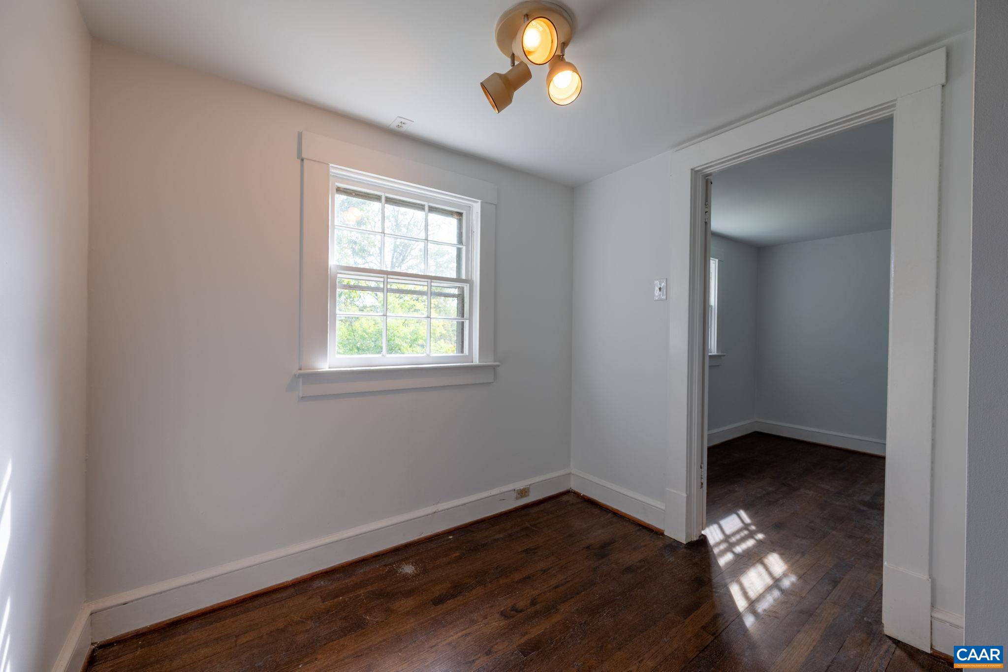 2514 Taylors Gap Road North Garden, VA 22959 - Photo 55 of 75 a view of an empty room with wooden floor and a window