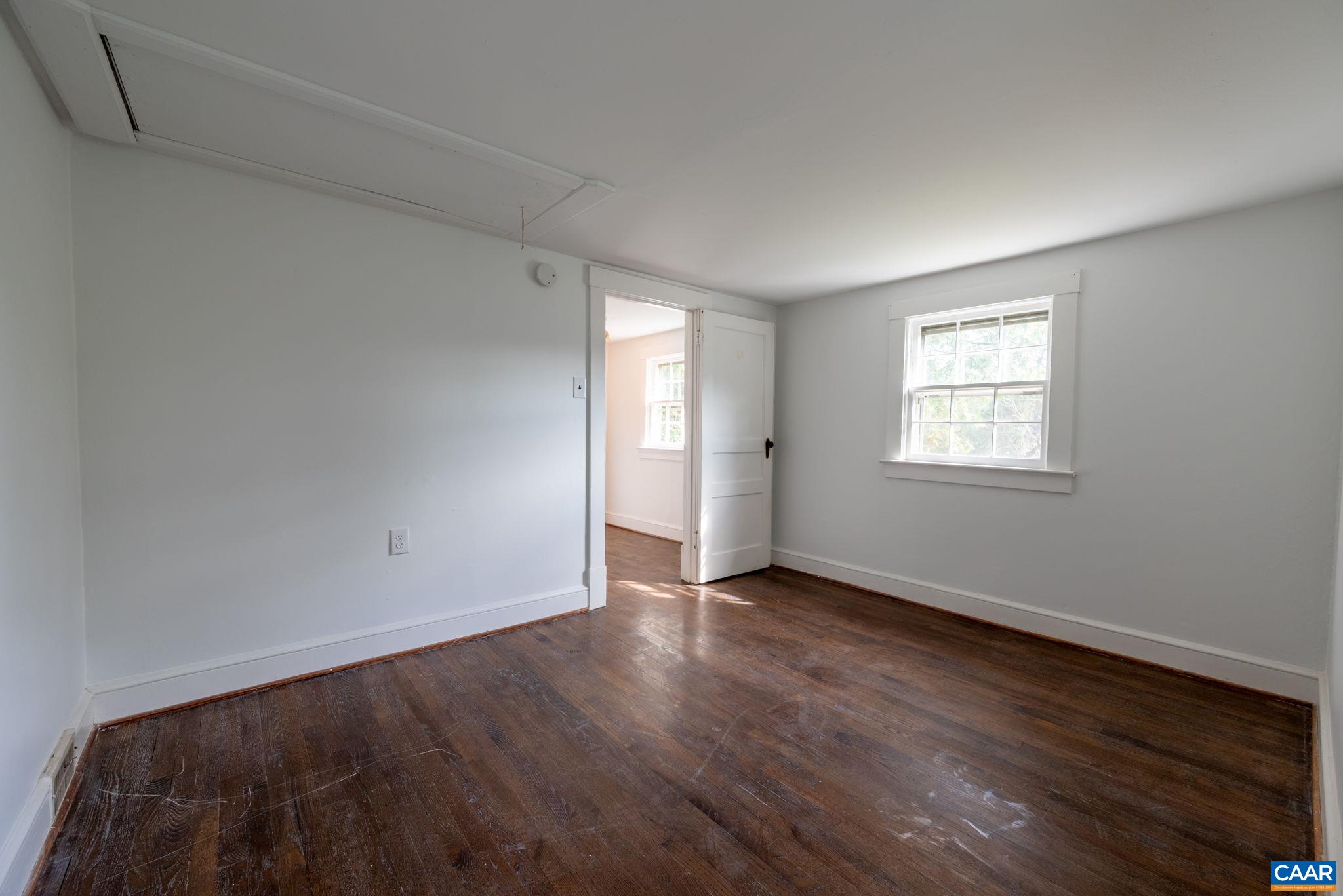 2514 Taylors Gap Road North Garden, VA 22959 - Photo 58 of 75 an empty room with wooden floor and windows