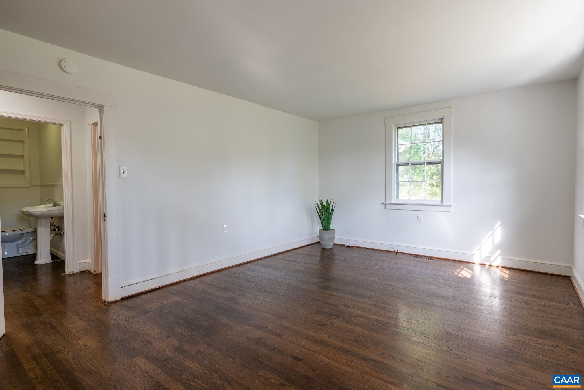 2514 Taylors Gap Road North Garden, VA 22959 - Photo 7 of 75 an empty room with wooden floor and a window