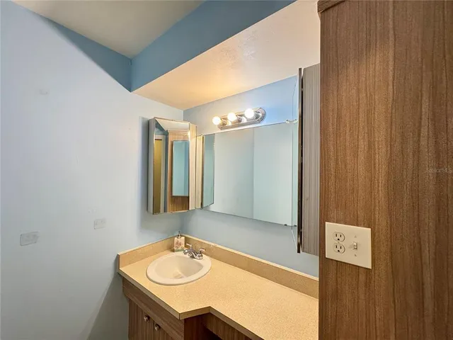 a bathroom with a sink and a mirror