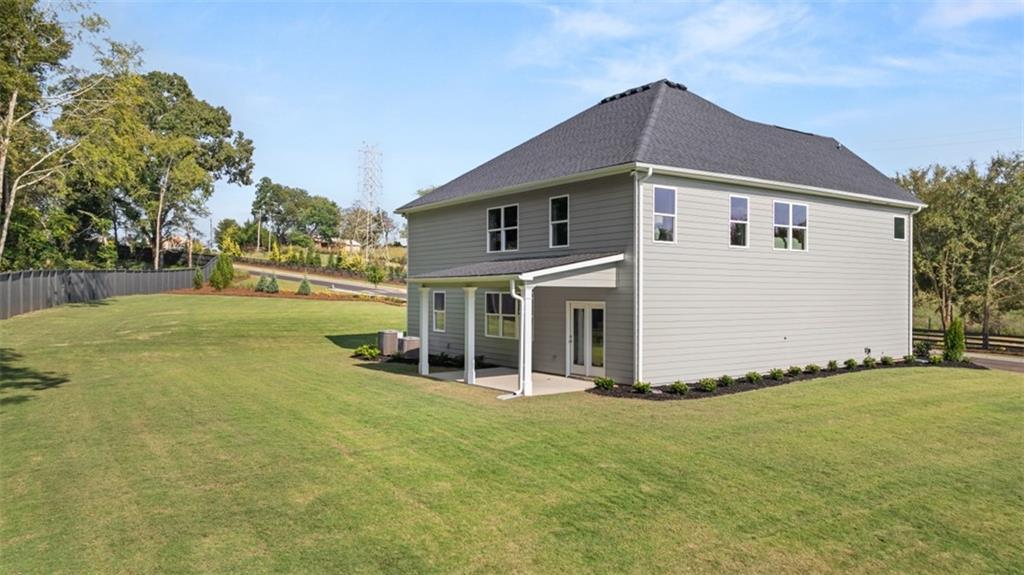 351 Bullock Pass Jefferson, GA 30549 - Photo 71 of 83 a front view of house with yard and trees in the background