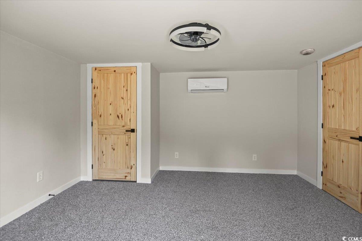 446 Sonny Road Gresham, SC 29546 - Photo 11 of 40 Carpeted spare room with an AC wall unit and baseboards