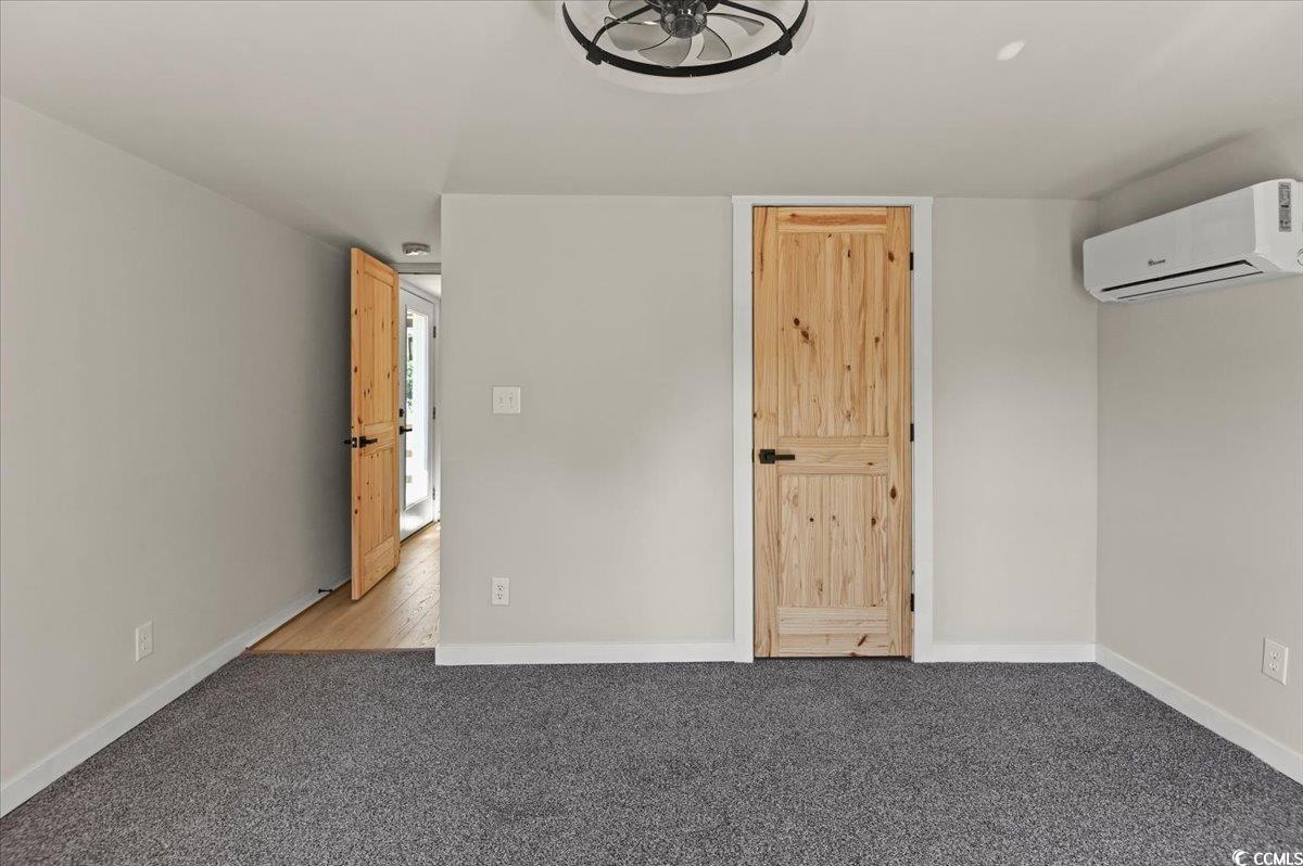 446 Sonny Road Gresham, SC 29546 - Photo 15 of 40 Carpeted spare room featuring baseboards and a wall unit AC