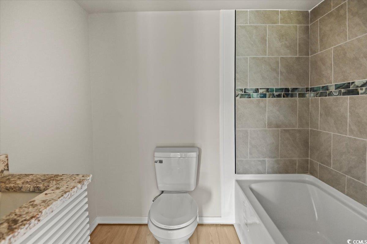 446 Sonny Road Gresham, SC 29546 - Photo 16 of 40 Full bathroom featuring wood finished floors, toilet, and baseboards