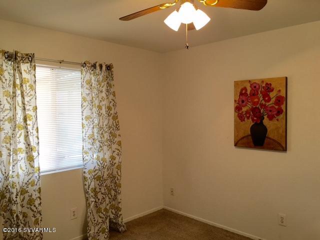 4165 North Pima Way Rimrock, AZ 86335 - Photo 10 of 22 a bathroom with a shower curtain and a window