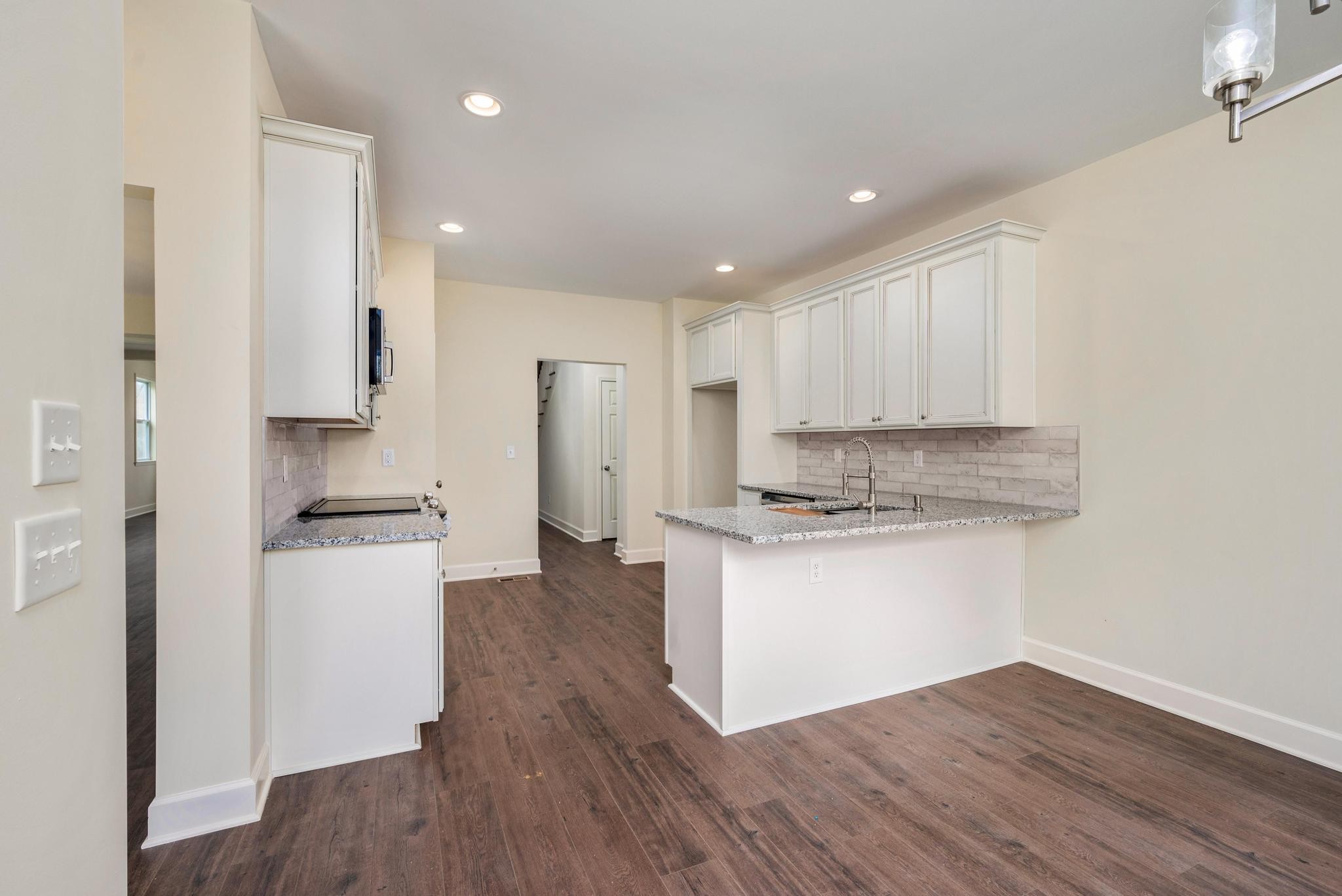 157 Lena Loop Burns, TN 37029 - Photo 12 of 49 a kitchen with granite countertop a refrigerator and a stove top oven