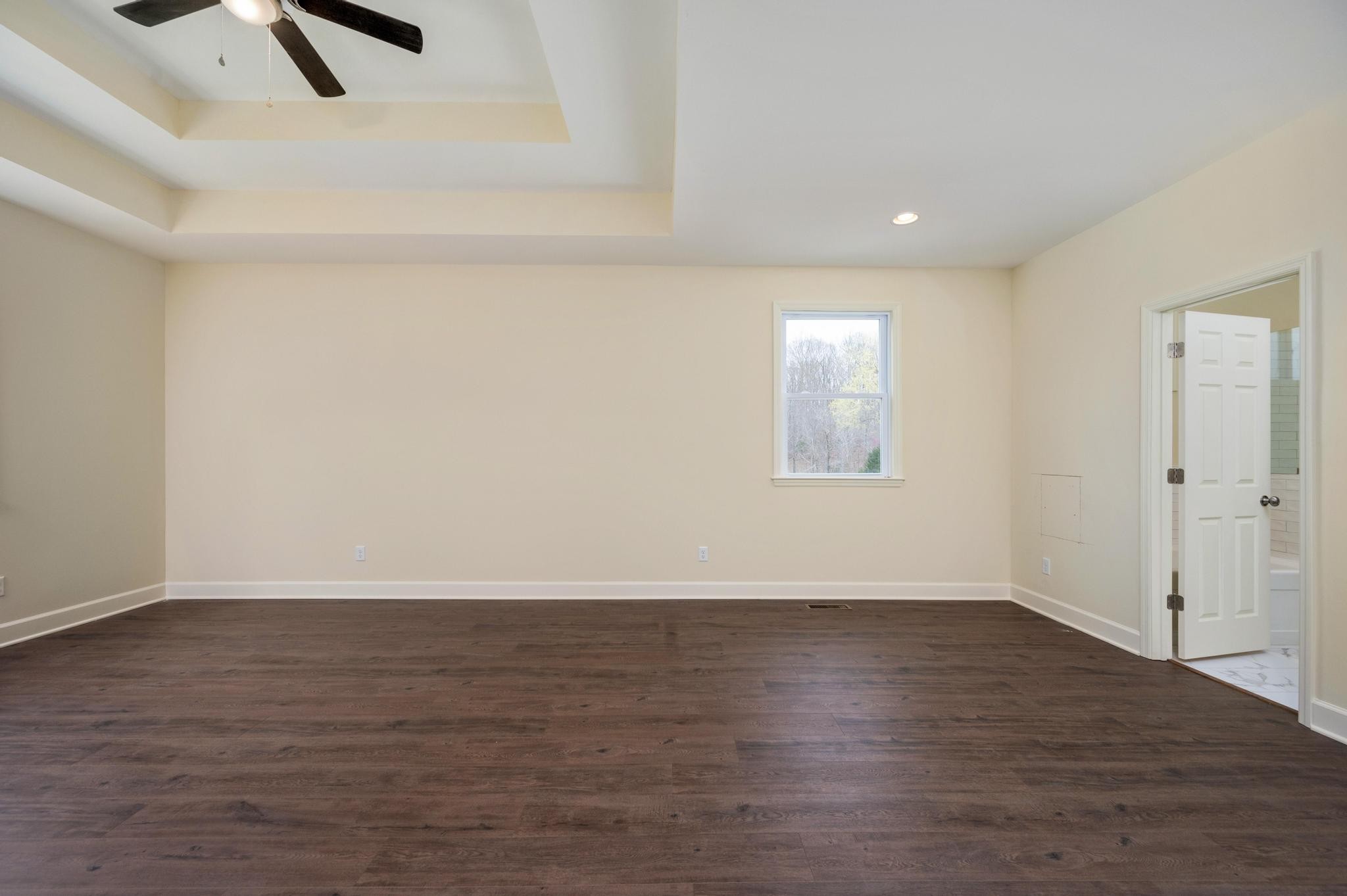 157 Lena Loop Burns, TN 37029 - Photo 16 of 49 an empty room with wooden floor and windows