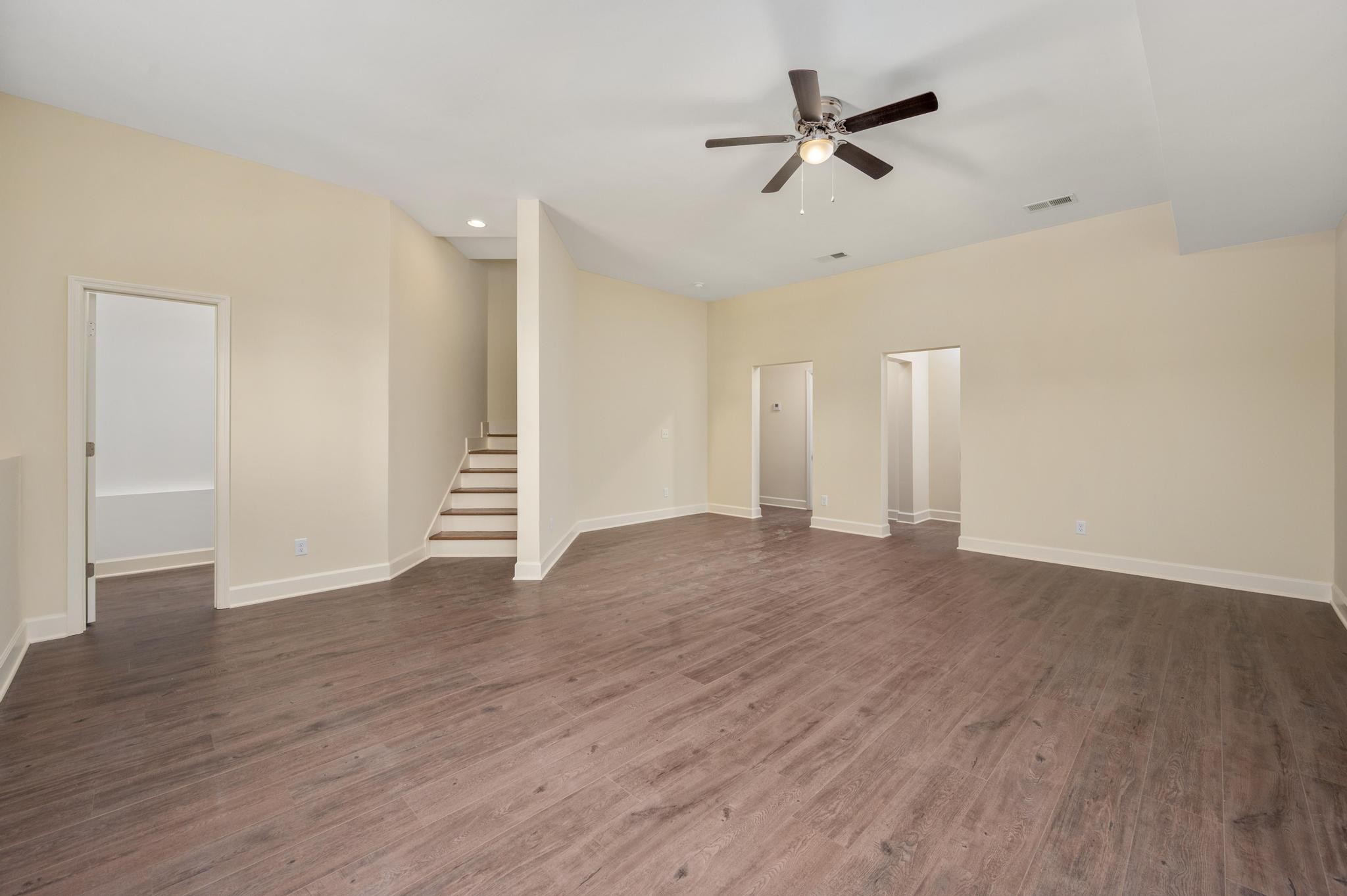 157 Lena Loop Burns, TN 37029 - Photo 22 of 49 a view of an empty room with a ceiling fan and wooden floor