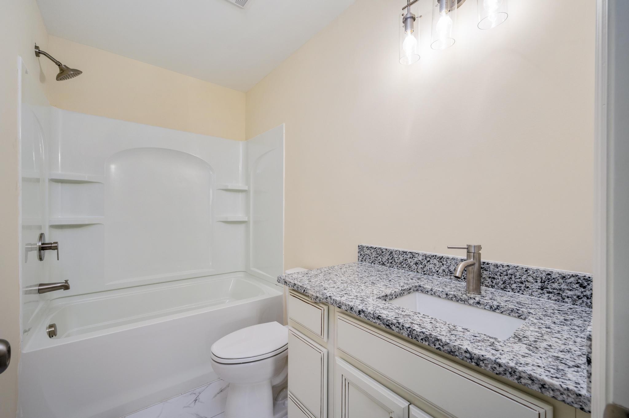 157 Lena Loop Burns, TN 37029 - Photo 23 of 49 a bathroom with a granite countertop sink a toilet and bathtub