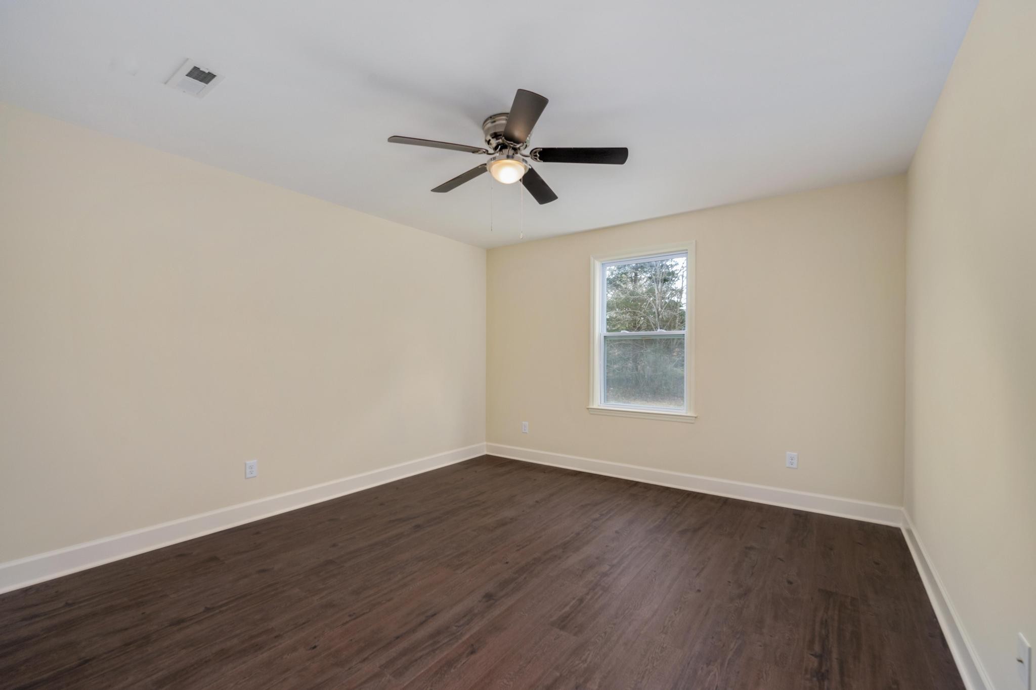 157 Lena Loop Burns, TN 37029 - Photo 24 of 49 a view of empty room with wooden floor and fan