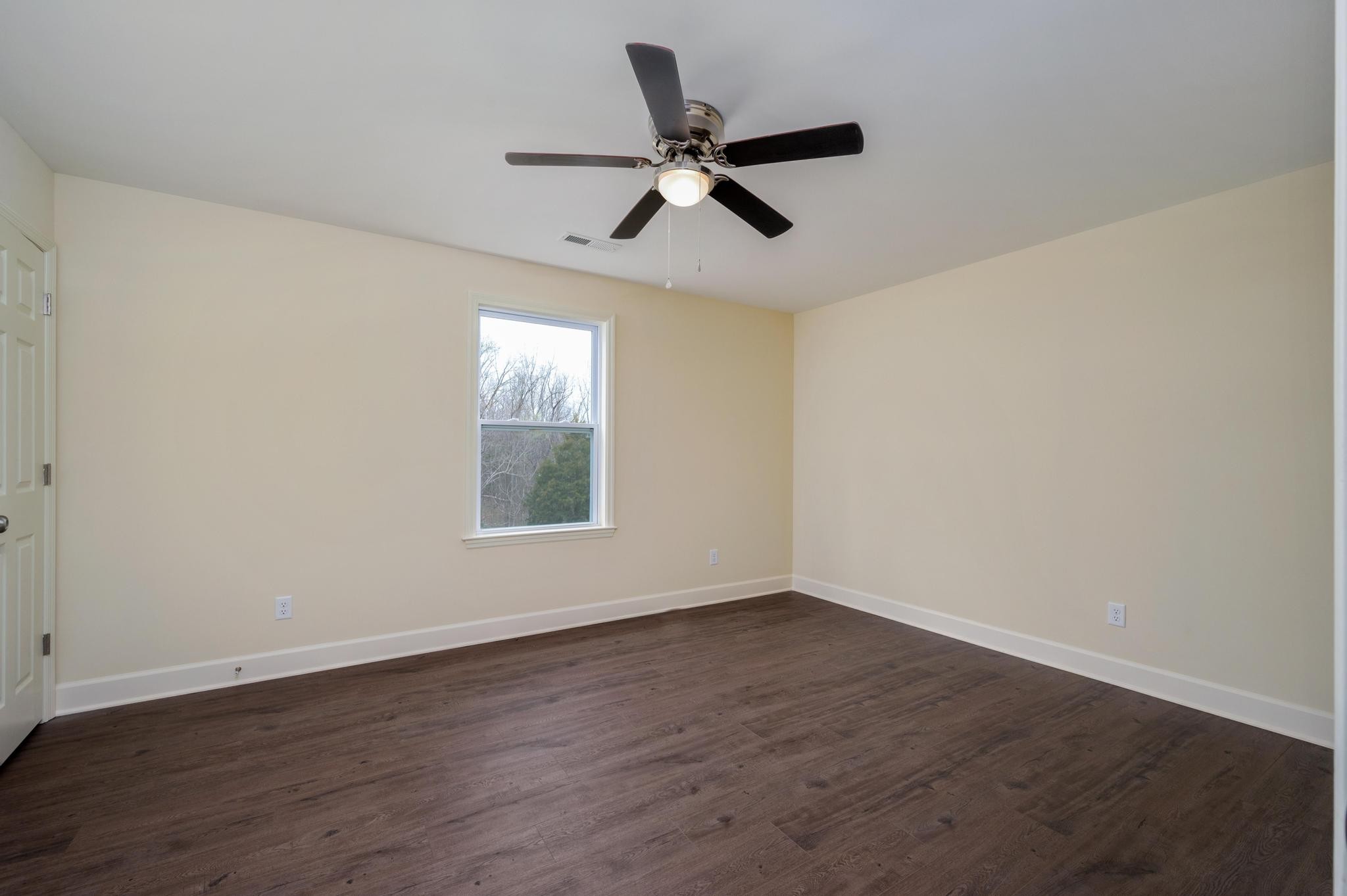 157 Lena Loop Burns, TN 37029 - Photo 25 of 49 a view of empty room with wooden floor