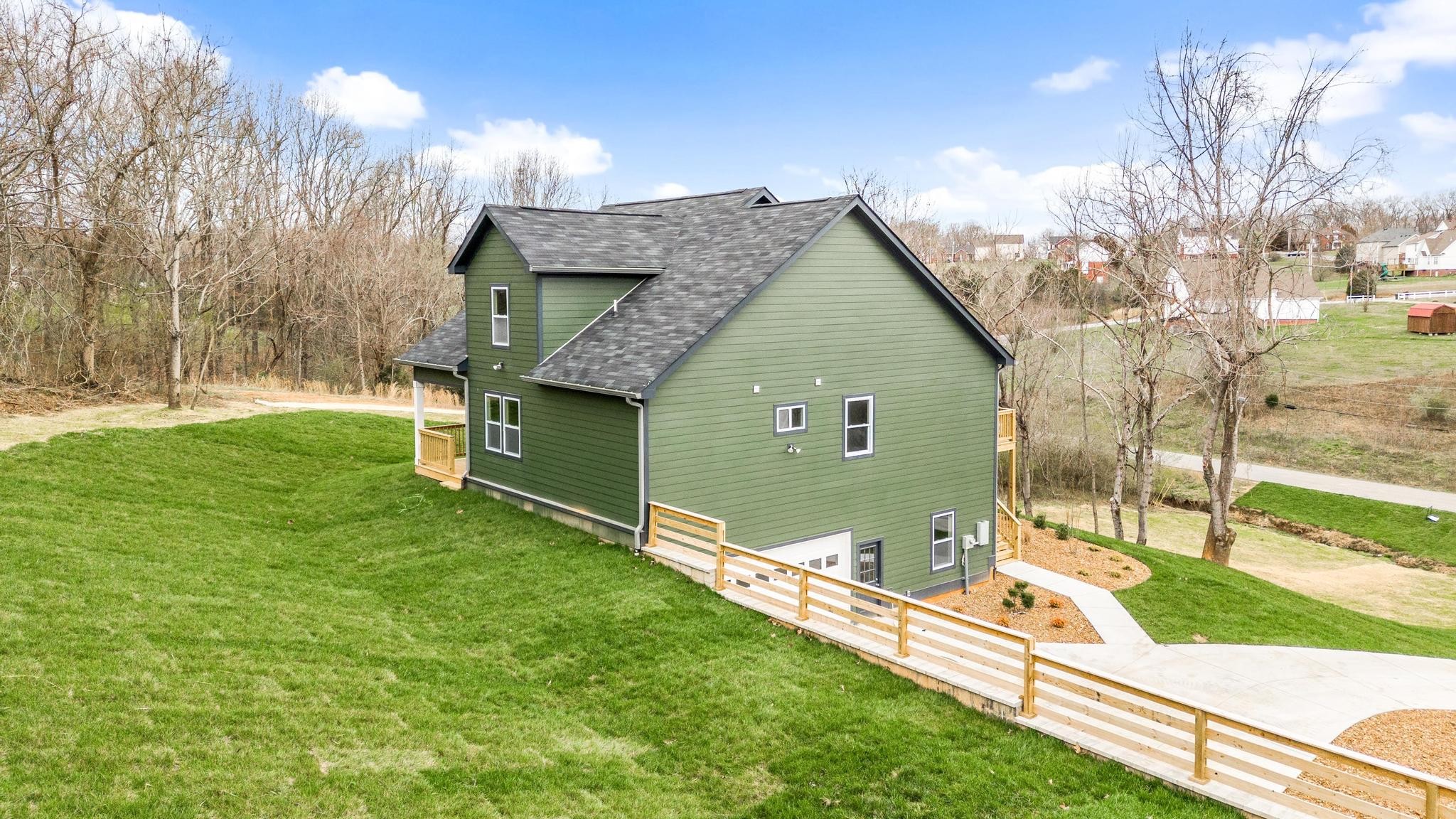 157 Lena Loop Burns, TN 37029 - Photo 32 of 49 a front view of a house with garden