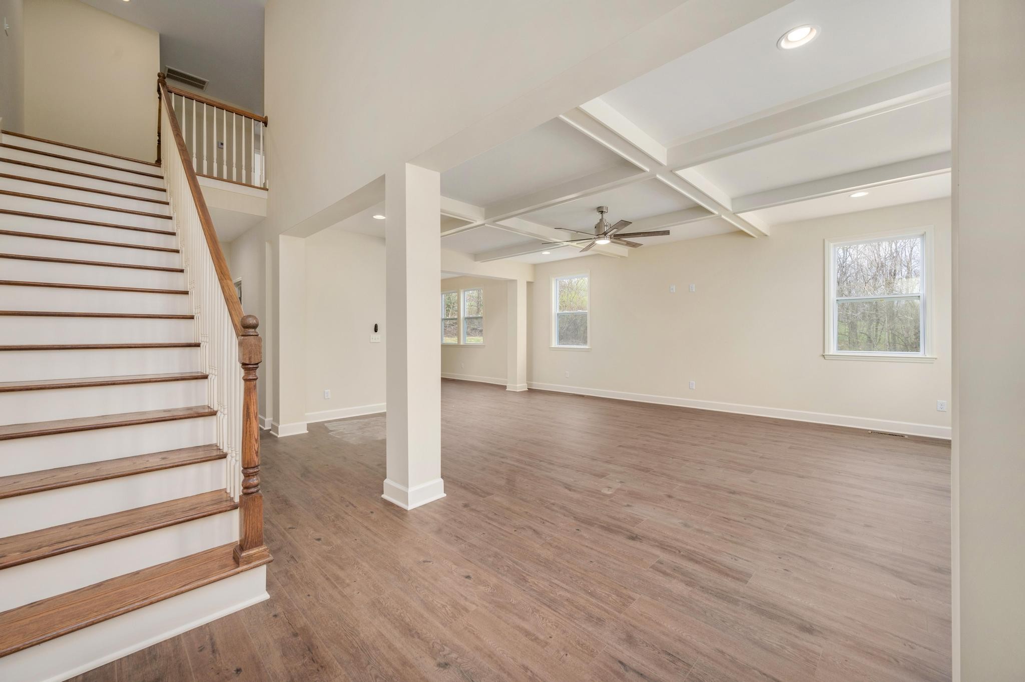 157 Lena Loop Burns, TN 37029 - Photo 4 of 49 a view of a livingroom with wooden floor and stairs
