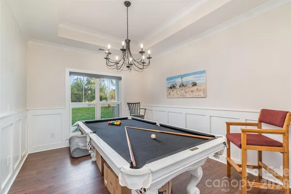 a room with table chairs and window