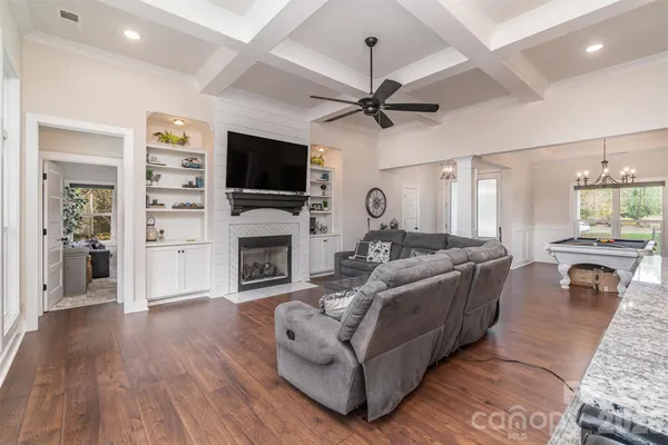 a living room with fireplace furniture and a flat screen tv
