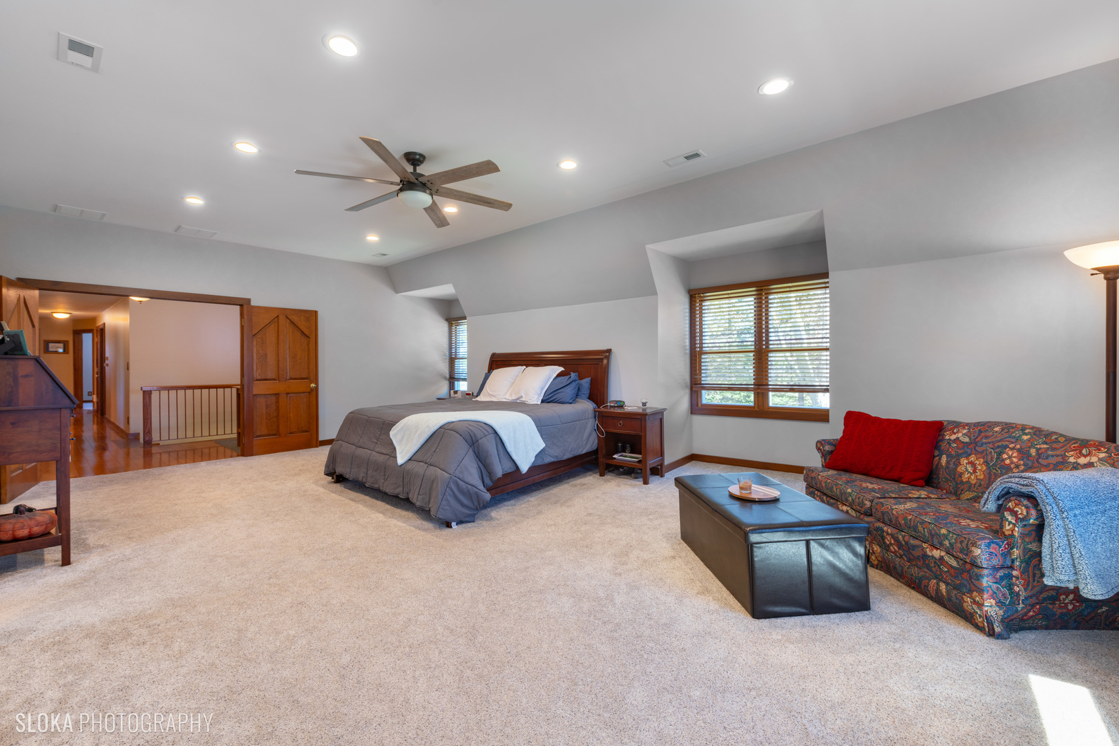 2401 West Wright Road Prairie Grove, IL 60012 - Photo 27 of 60 a spacious bedroom with a bed a couch and a chandelier