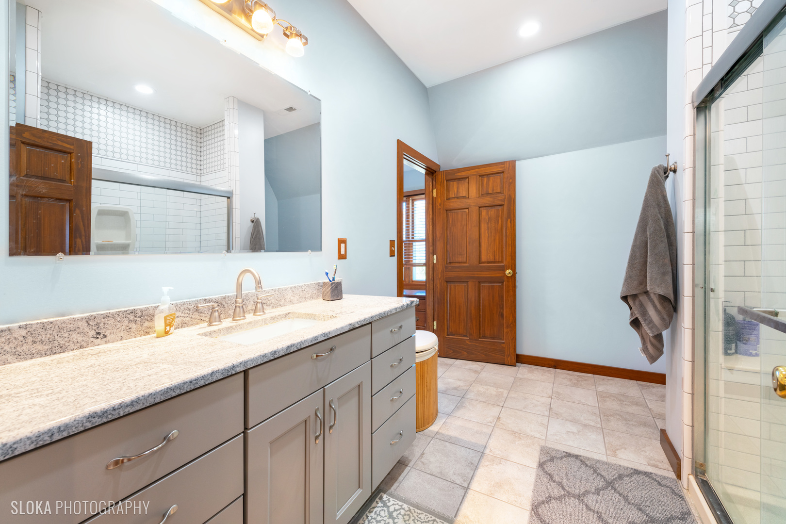 2401 West Wright Road Prairie Grove, IL 60012 - Photo 30 of 60 a spacious bathroom with a granite countertop sink and a mirror