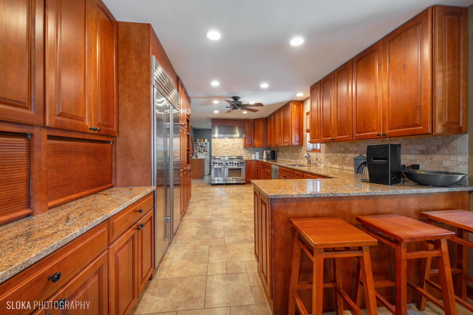 2401 West Wright Road Prairie Grove, IL 60012 - Photo 8 of 60 a large kitchen with stainless steel appliances wooden cabinets and a stove top oven