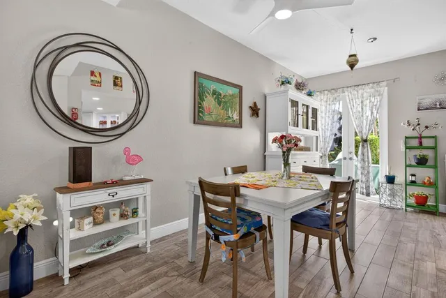 a dining room with furniture and a wooden floor