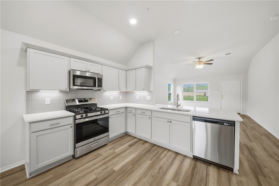1220 High Street Navasota, TX 77868 - Photo 12 of 27 a kitchen with stainless steel appliances granite countertop a stove a sink dishwasher and a refrigerator